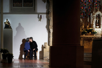 Zwei Menschen küssen sich in einer Kirche